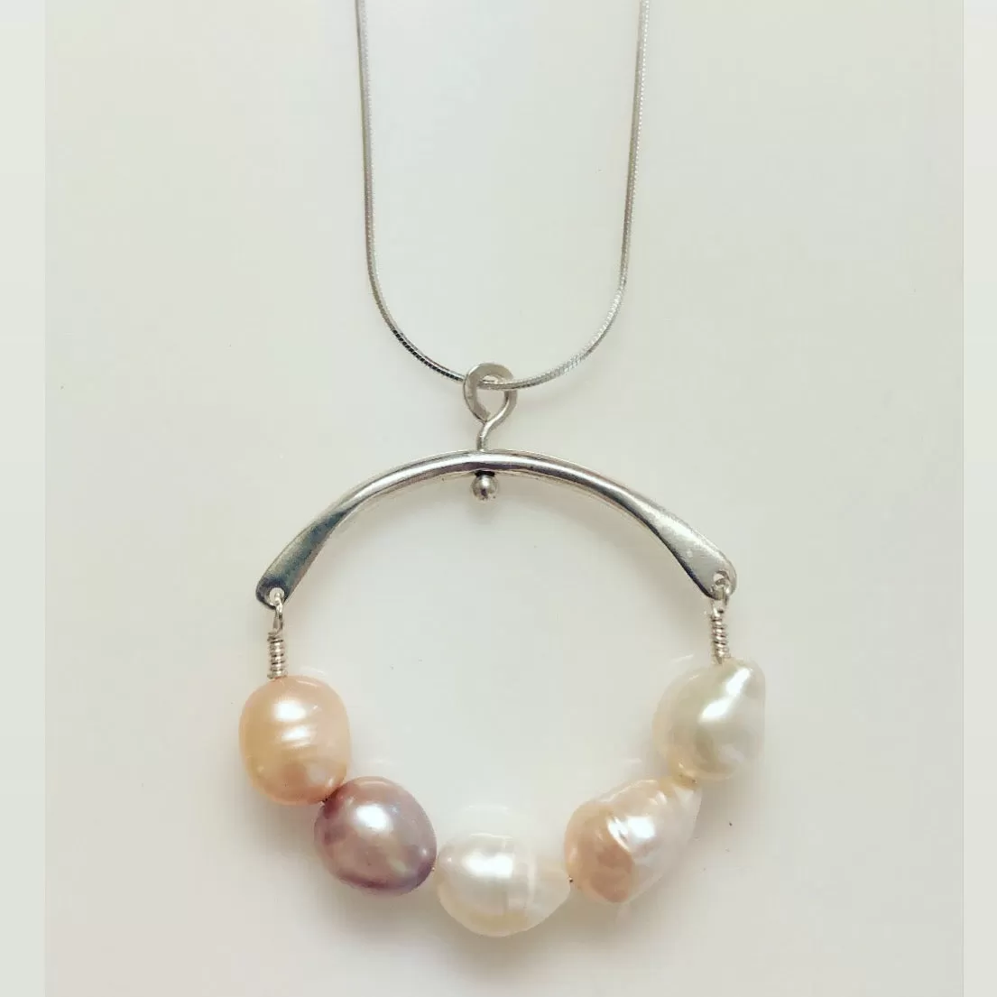 Forged Arc Pearl in white and pink.